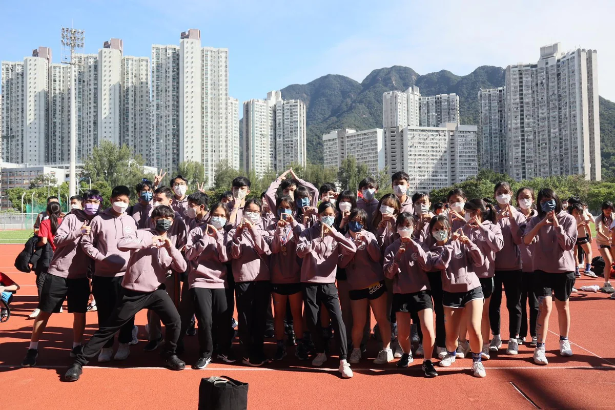 成班同學著粉紅色班衫喺運動場合照